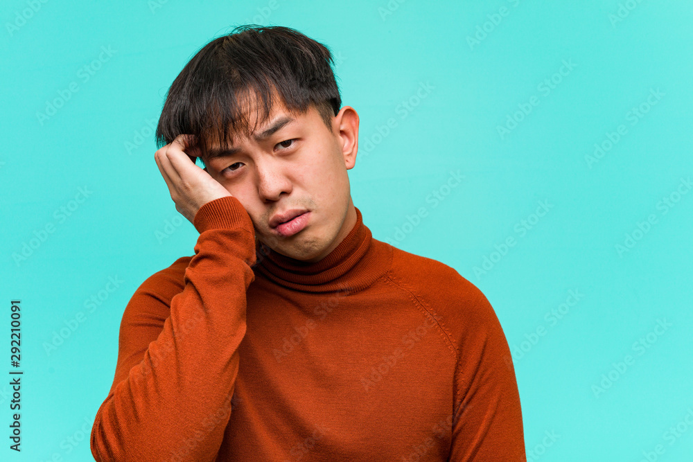 Young chinese man tired and very sleepy Young chinese man tired and very sleepy