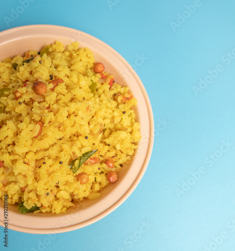 Close up of Fresh Poha or Pohy is a popular Indian breakfast on on bowl photo