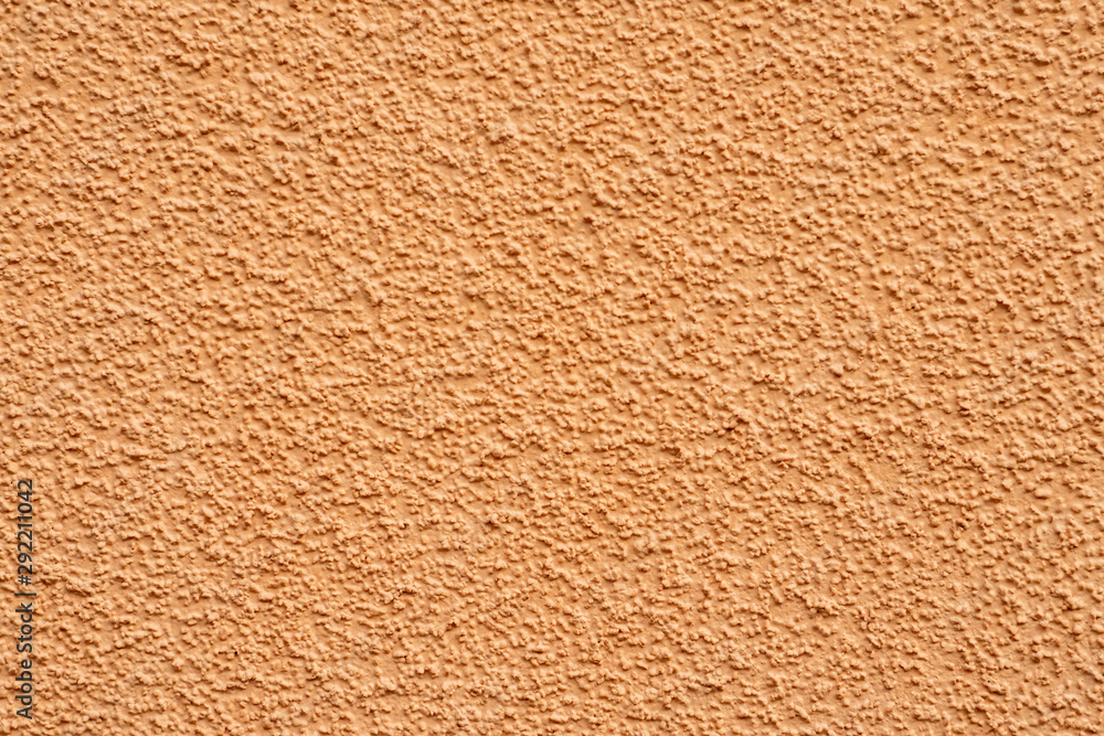 A fragment of the wall of the house. Plaster of beige sand color. Granulated surface A fragment of the wall of the house. Plaster of beige sand color. Granulated surface