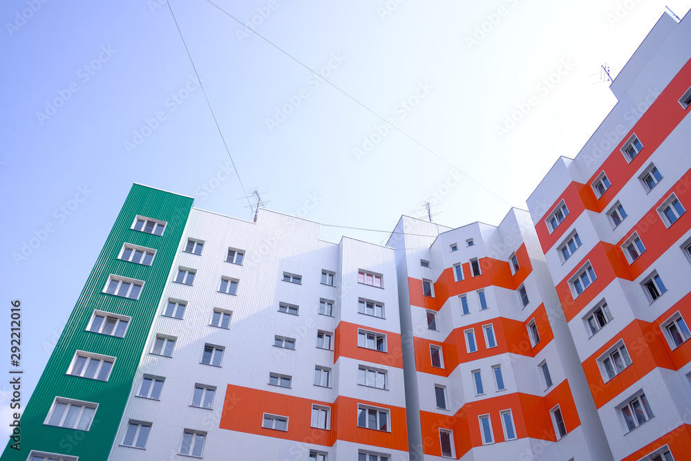 Multistory apartments house. Modern executive apartments house. Bright blue sky as background
