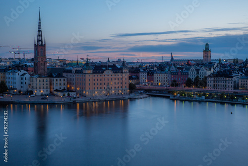 A colorful sunrise over Stockholm with the lights reflecting on the calm water of the sea - 4