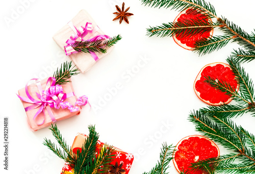 Fototapeta Naklejka Na Ścianę i Meble -  Gift box on the texture of fir branches on white isolated background. New Year or Christmas decor