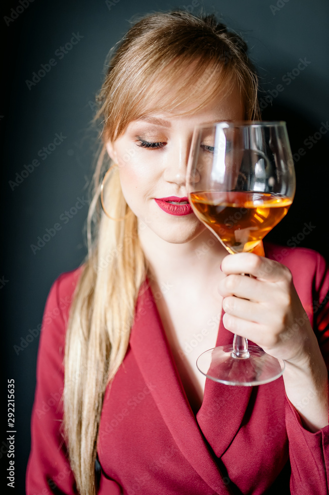 woman in red holding wine glass and smiles woman in red holding wine glass and smiles