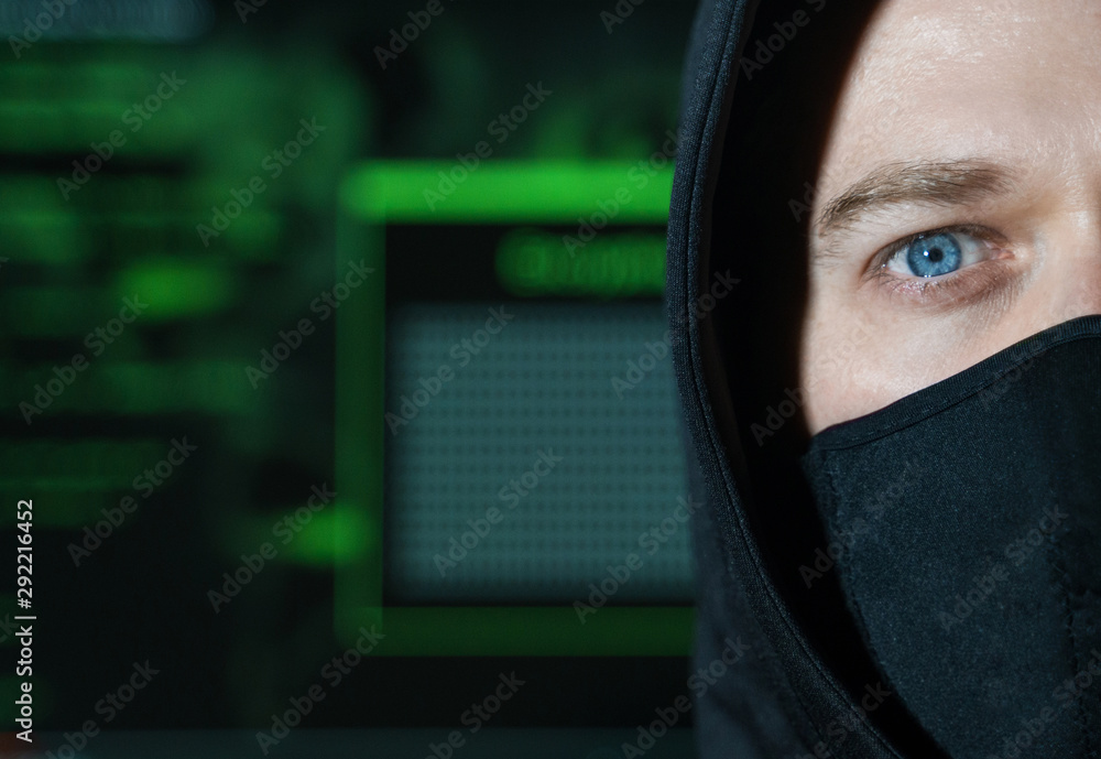 Hacker in black mask. Hacking and internet security concept. Hacker in black mask. Hacking and internet security concept.