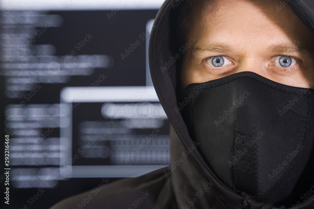 Hacker in black mask. Hacking and internet security concept.