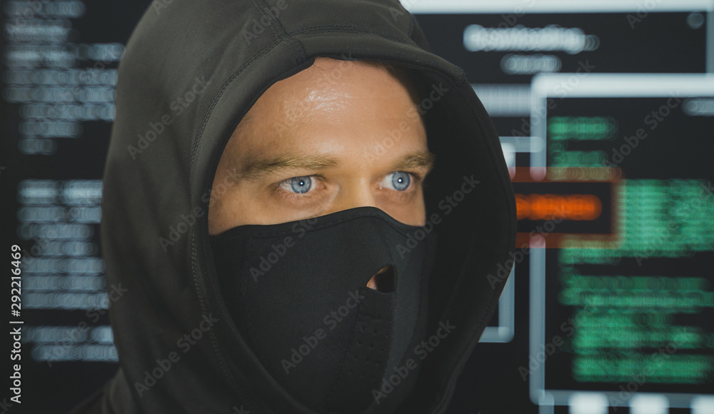 Hacker in black mask. Hacking and internet security concept. Hacker in black mask. Hacking and internet security concept.