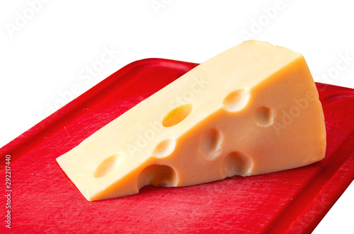Cheese with holes on red board isolated on white