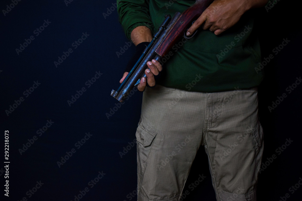 asian man holds a gun. Gun in his hand isolated on black background. asian man holds a gun. Gun in his hand isolated on black background.