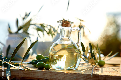 olive oil and green olive on the wooden background