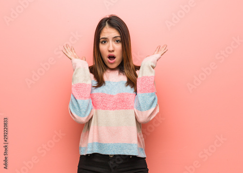 Young cute woman surprised and shocked
