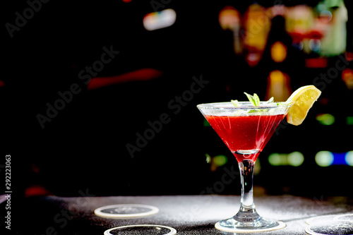 Red cocktail similar to a Margarita covered with powdered sugar is on the bar. photo