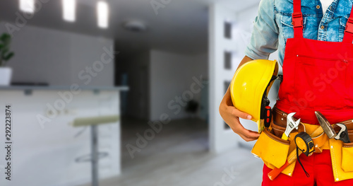 Builder handyman with construction tools. House renovation background. photo