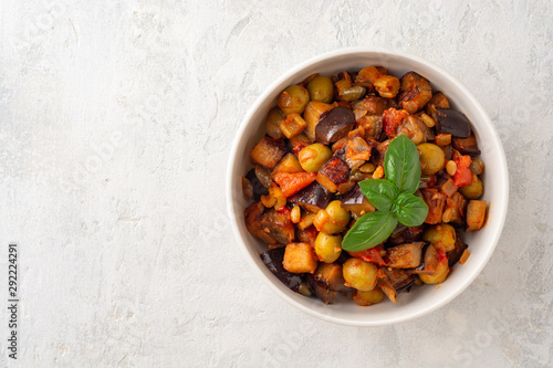 Traditional sicilian eggplant dish Caponata in bowl on concrete background. Top view. Copy space.