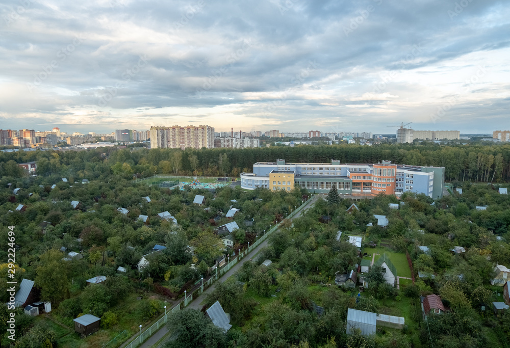 Panoramic view of residential new buildings of the city, surrounded by trees.