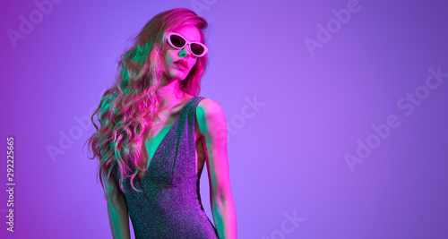 Fashion contemporary neon style. Graceful Beautiful woman in party bodysuit dance. Disco summer vibes. Adorable fashionable sexy model. Fitness girl portrait. Creative art pink purple neon color