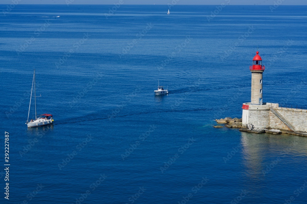 Boats passing a lighthouse Boats passing a lighthouse