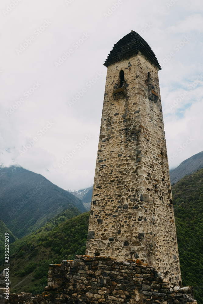 Ingush watchtower on a background of the Caucasus mountains Ingush watchtower on a background of the Caucasus mountains
