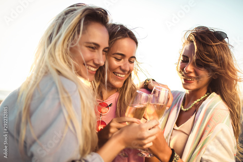 Wall Mural Friends having fun with champagne at celebration on beach, selective focus