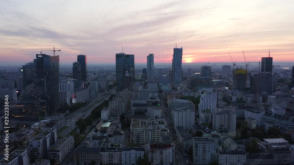 Drone shot flying around the city of Warsaw at sunrise. Aerial view of the center of Warsaw with skyscrapers and buildings at sunrise. Drone shot flying around the city of Warsaw at sunrise. Aerial view of the center of Warsaw with skyscrapers and buildings at sunrise.