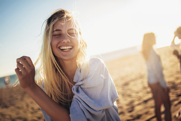 Beautiful girls in a summer day having fun on the beach, selective focus.