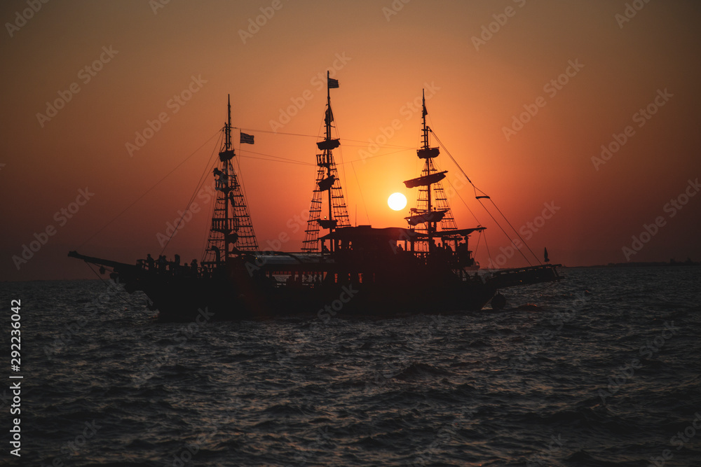 An old Greek galleon view from the Aegean sea during sunset