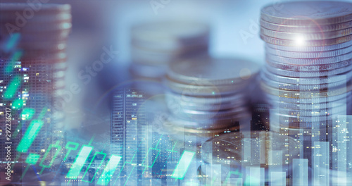 Financial investment concept, Double exposure of city night and stack of coins for finance investor, Forex trading candlestick chart, Cryptocurrency Digital economy. economy growing.