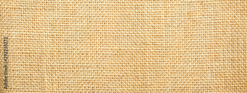 Cotton woven fabric background with flecks of varying colors of beige and brown. with copy space. office desk concept / Hessian sackcloth burlap woven texture background