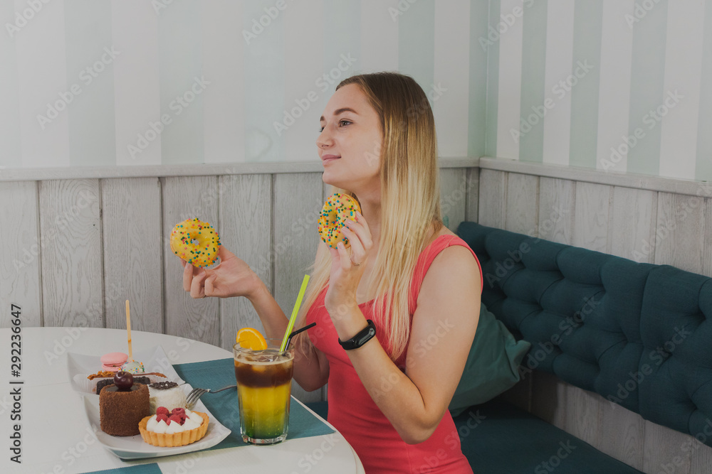 Girl in a cafe eats sweet and fresh desserts. Girl in a cafe eats sweet and fresh desserts.
