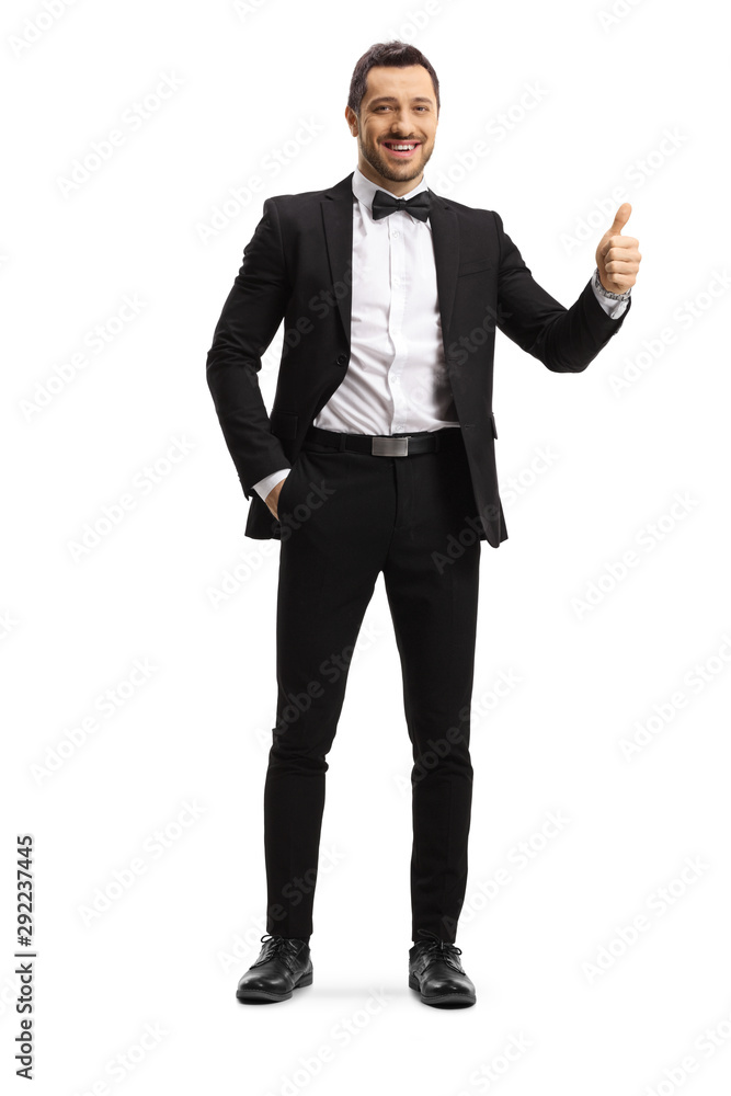 Young elegant man in a suit and bow showing thumbs up Young elegant man in a suit and bow showing thumbs up