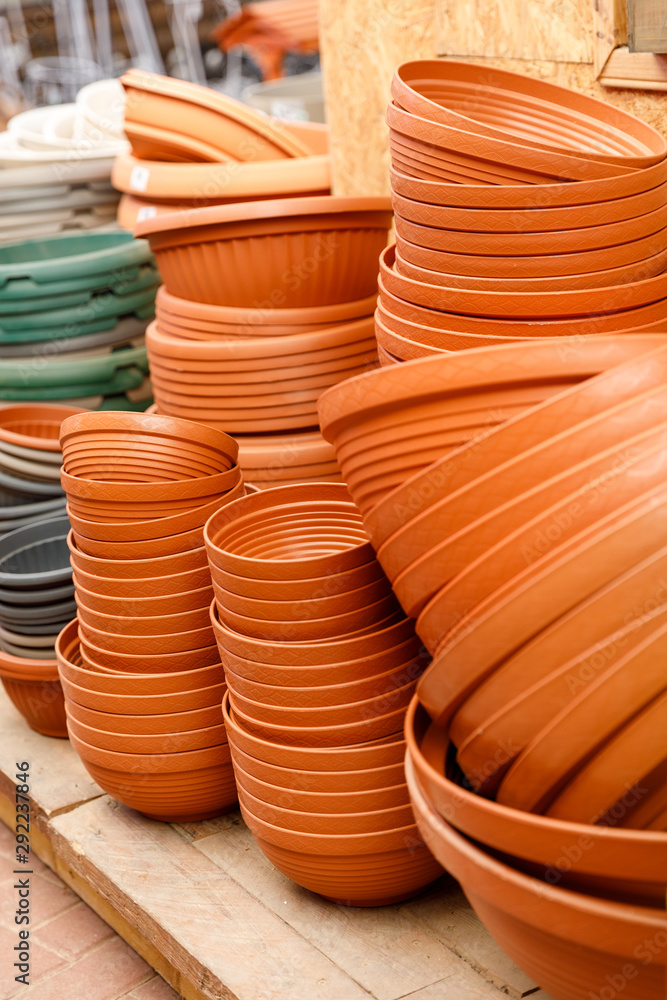 Closeup view on pladtic pots on the shelves in the greenhouse Closeup view on pladtic pots on the shelves in the greenhouse