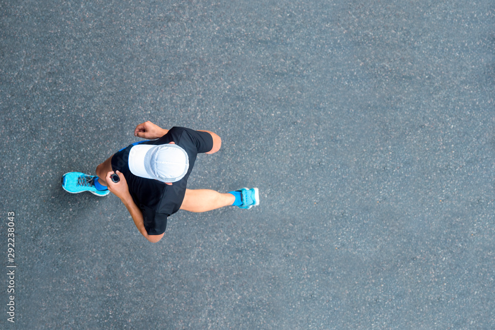 © Augustas Cetkauskas - Man sprinting in the morning outdoors. Top view of male runner working out in the city. © Augustas Cetkauskas - Man sprinting in the morning outdoors. Top view of male runner working out in the city.