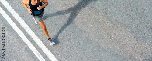 Close up of runner feet. Fitness background, close up of runner feet on the road. photo