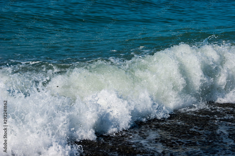 The sea worries once - a light storm at sea, a wave runs onto a pebble beach, the Black Sea coast