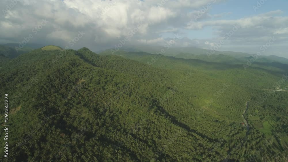 Aerial view of mountains covered forest, trees. Cordillera region. Luzon, Philippines. Slopes of mountains with evergreen vegetation. Mountainous tropical landscape. Aerial view of mountains covered forest, trees. Cordillera region. Luzon, Philippines. Slopes of mountains with evergreen vegetation. Mountainous tropical landscape.