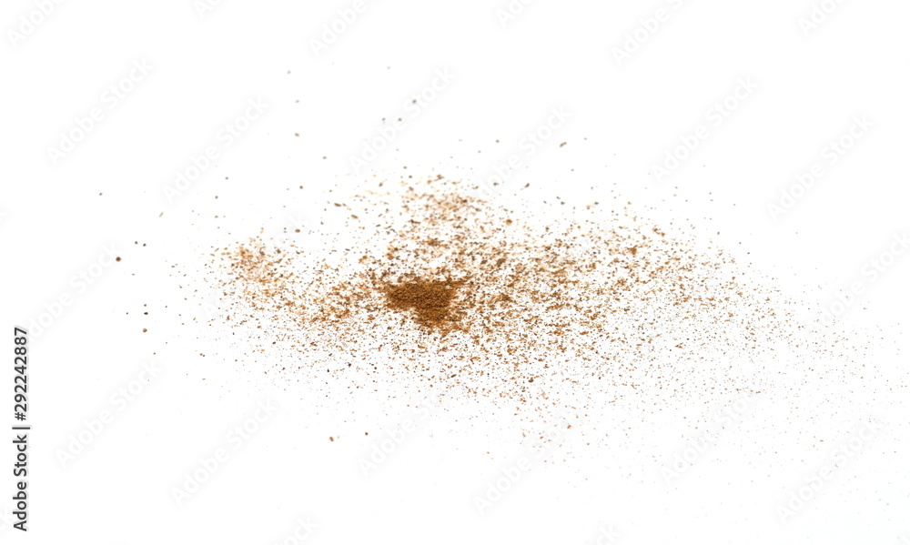 Spice cinnamon powder isolated on a white background. Cinnamon powder spilled on a white surface. Spice cinnamon powder isolated on a white background. Cinnamon powder spilled on a white surface.