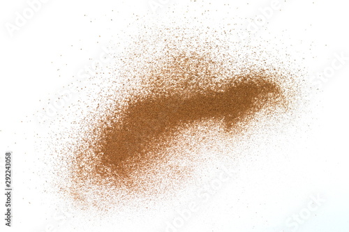 Spice cinnamon powder isolated on a white background. Cinnamon powder spilled on a white surface.