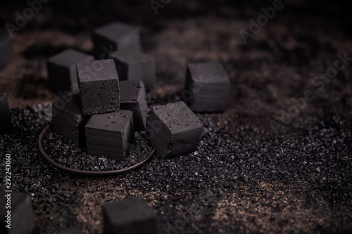 Charcoal for hookah on the old rustic wood table