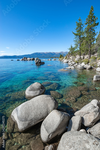 USA, Nevada, Washoe County, Lake Tahoe. Granite boulders above the clear blue to emerald waters near Bonsai Rock.