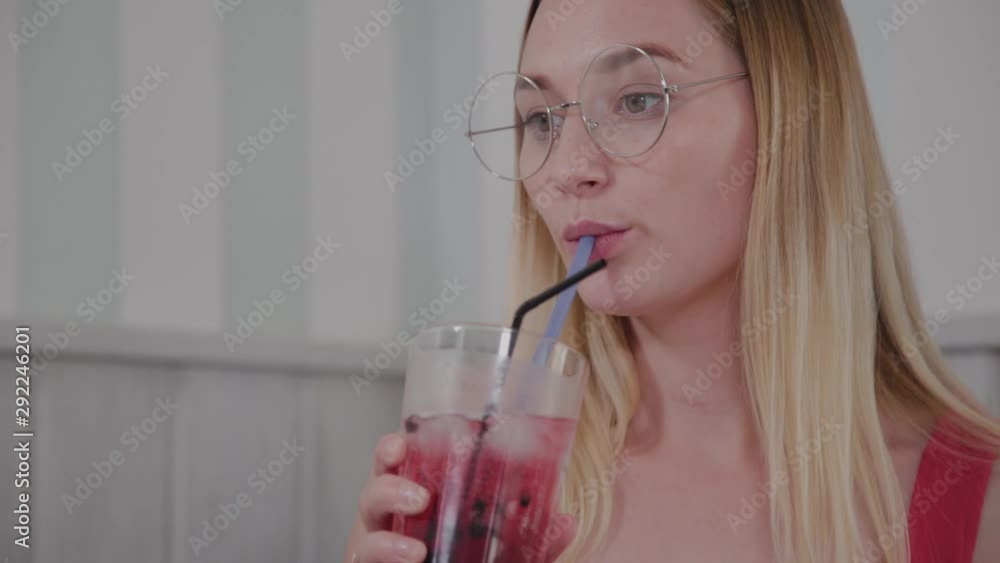 Beautiful girl drinks a cocktail in a restaurant. Beautiful girl drinks a cocktail in a restaurant.
