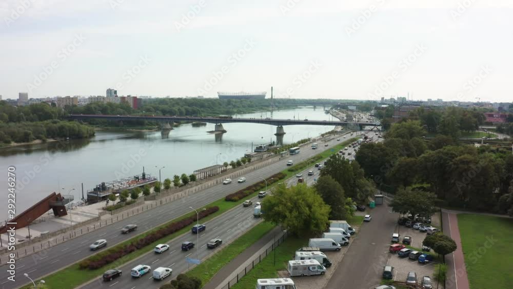 Incredible aerial shot of a freeway, traffic passes through a bridge and an automobile intersection. Drone shot on a highway with traffic in the old city of Warsaw. Incredible aerial shot of a freeway, traffic passes through a bridge and an automobile intersection. Drone shot on a highway with traffic in the old city of Warsaw.