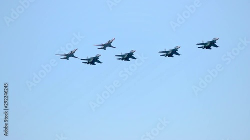 Column of six military warplanes flies over the ground. Military helicopters and planes in the evening sky. Air force parade. Independence Day parade in the CIS country. Belarus 3 July 2019.