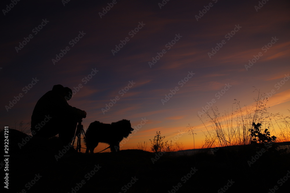 Silhouette of photographer and a dog