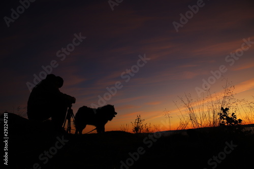 Silhouette of photographer and a dog