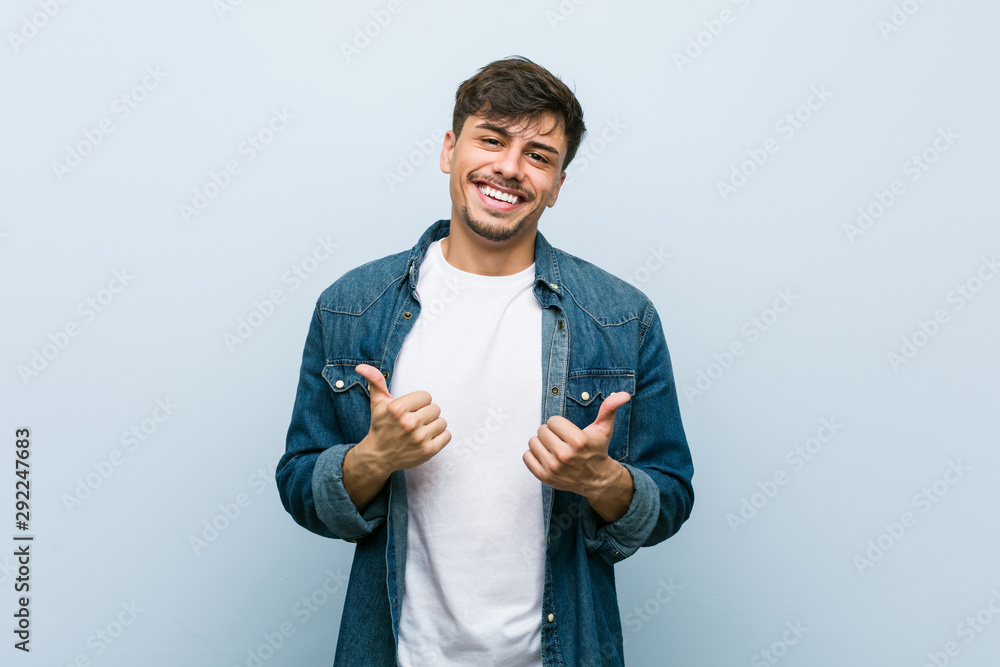 Young hispanic cool man raising both thumbs up, smiling and confident. - obrazy, fototapety, plakaty 