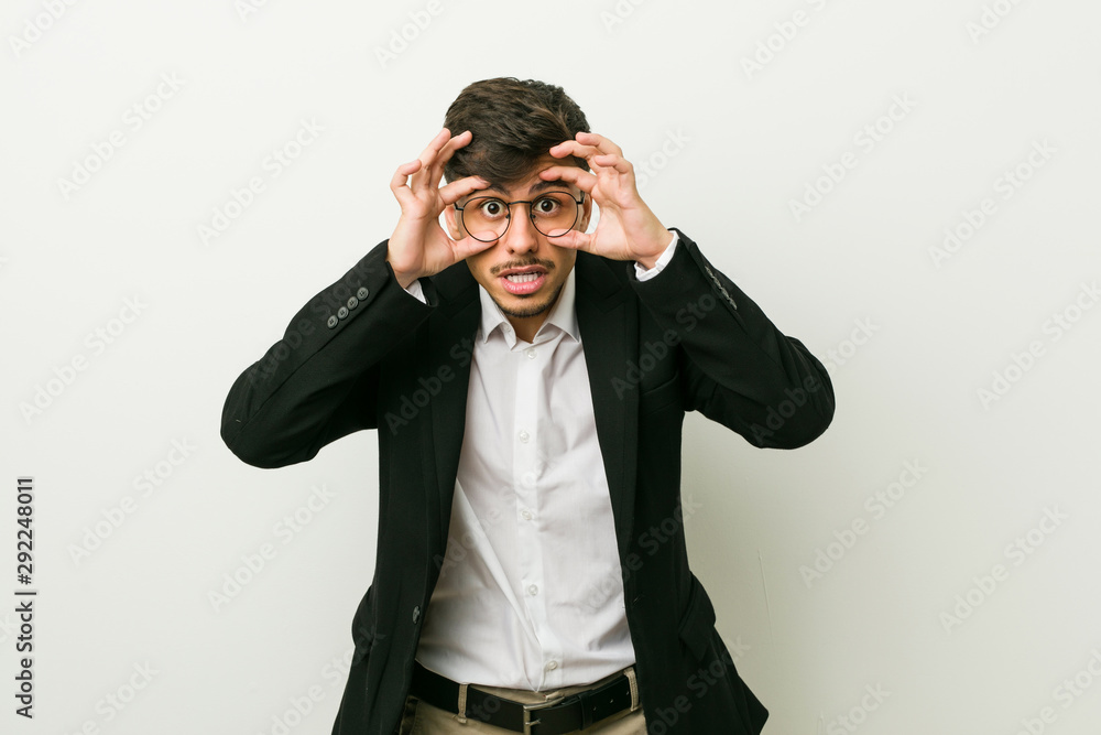 Young business hispanic man keeping eyes opened to find a success opportunity. Young business hispanic man keeping eyes opened to find a success opportunity.