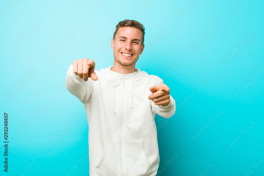 Young caucasian sport man cheerful smiles pointing to front. Young caucasian sport man cheerful smiles pointing to front.