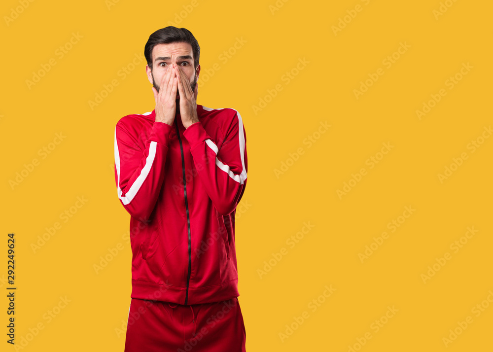 Young fitness man very scared and afraid hidden Young fitness man very scared and afraid hidden