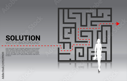 Silhouette of Businesswoman standing with plan to exit from maze . Business concept for problem solving and solution strategy