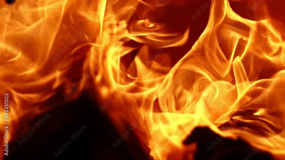 Burning Firewood. This video captures a close-up of wood burning in a fireplace, emitting waves of flame. Burning Firewood. This video captures a close-up of wood burning in a fireplace, emitting waves of flame.