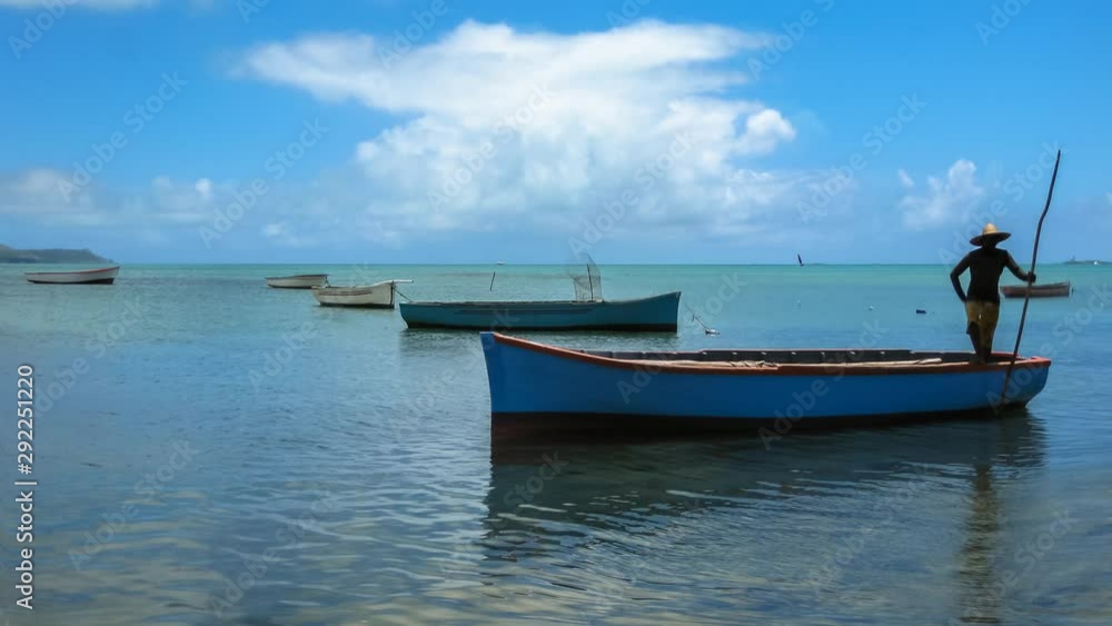 Silhouette of a fisherman on a boat in the water, Ile aux Aigrettes Nature Reserve, Mauritius in the Indian Ocean. Cinemagraph loop background. Silhouette of a fisherman on a boat in the water, Ile aux Aigrettes Nature Reserve, Mauritius in the Indian Ocean. Cinemagraph loop background.